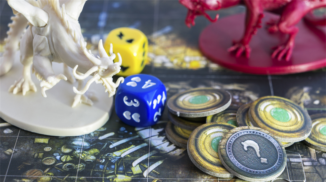 Board game with dice on table and coins