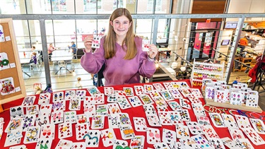 Young teenager girl selling handmade earrings at Kid Makers Market