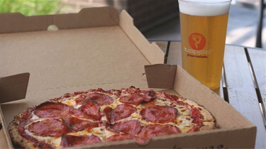 Pepperoni pizza and beer on patio outside Public Market