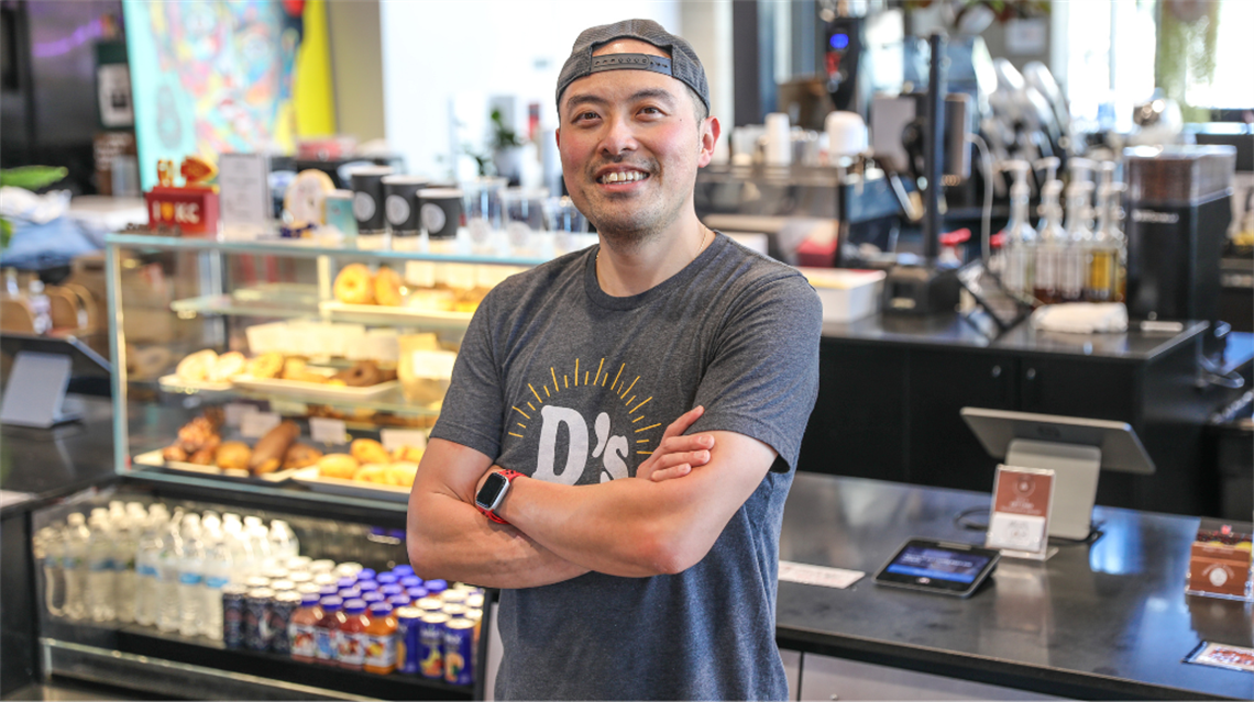 Chef/owner of Mr. D's Coffee Johnny Chen standing in front of his merchant stall