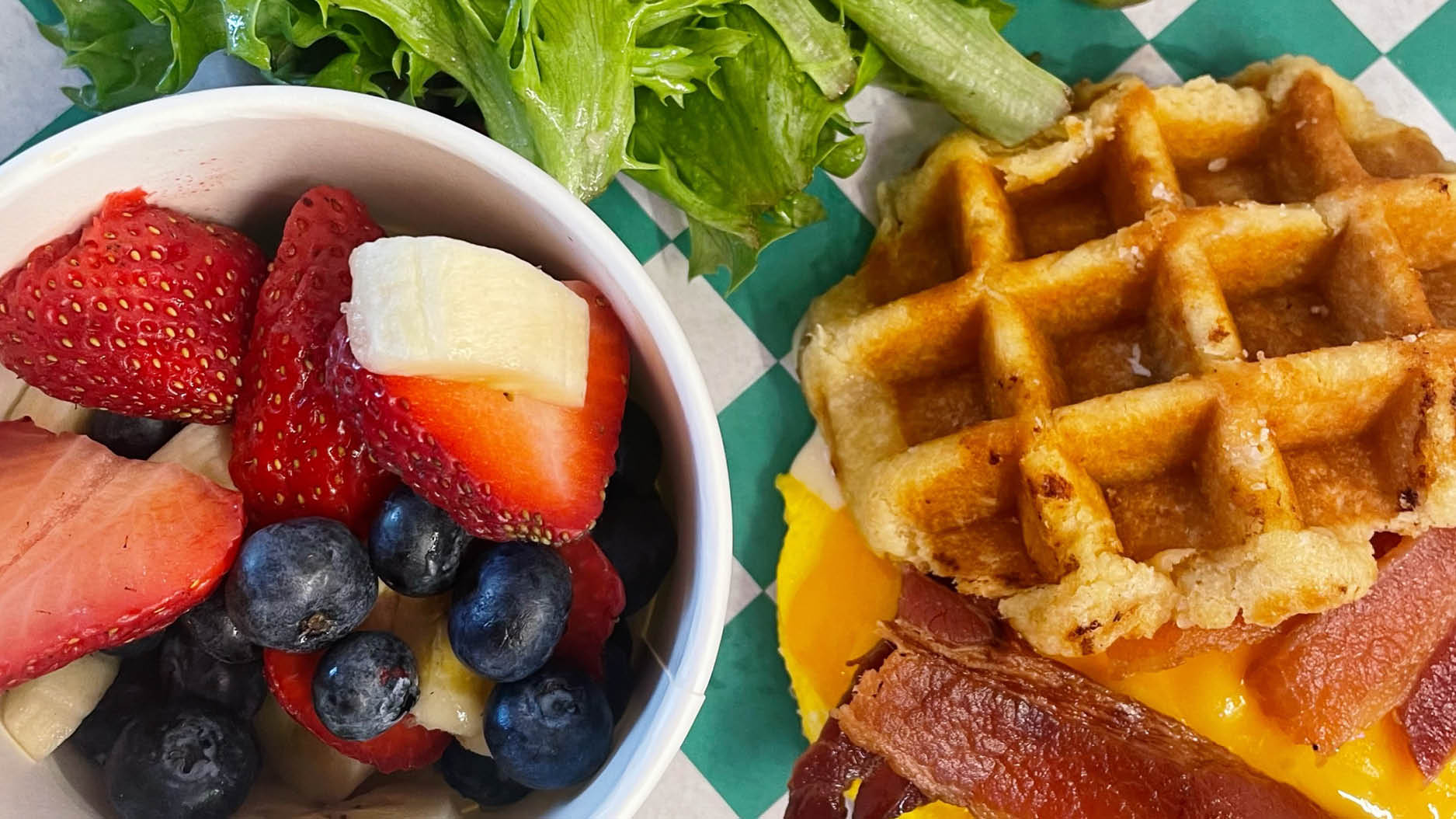 bowl of fruit and waffle sandwich